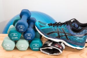 Physical injury chiropractor in west palm beach shows tennis shoe and weights for physical therapy